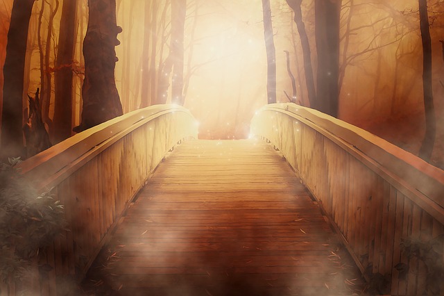 a bridge going up to a golden light