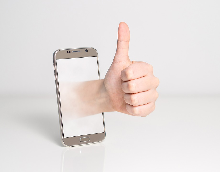 Thumb up, beside a cell phone