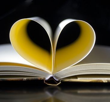 An open book with a heart on top