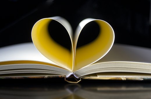 An open book with a heart on top