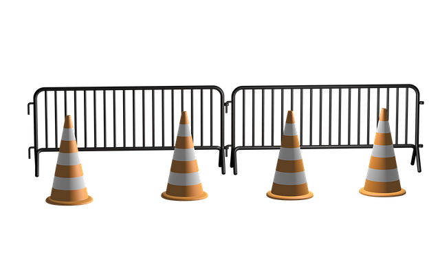 two steel blockades with an orange cone in front of each one.