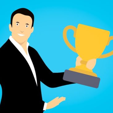 Businessman holding a brass trophy