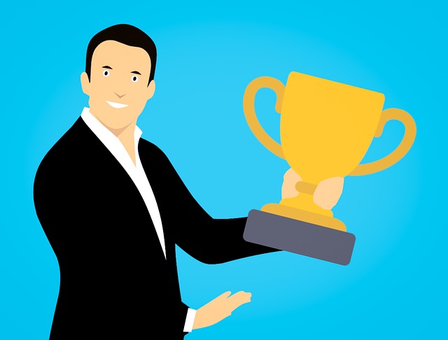 Businessman holding a brass trophy