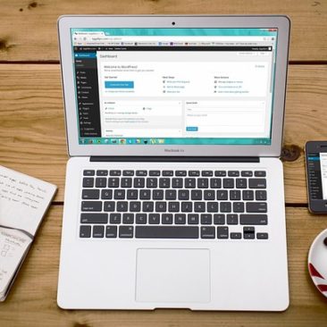 Open laptop with note pad and tape recorder