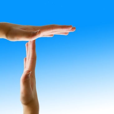Two hands making a time out signal