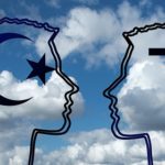 Is Islam a religion of peace 2 outlines of people had shoulders are superimposed over a blue cloudy background inside each outline is a religious symbol. On the left is the symbol for Islam. On the right is the symbol for Christianity