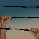 video game addiction two hands each holding a strand of barb wire