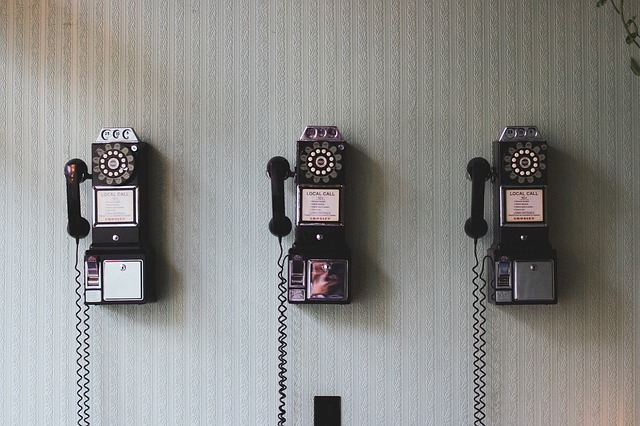 three old rotary phones
