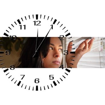 face, hand, clock in background